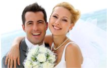 Smiling bridal couple with bouquet of flowers